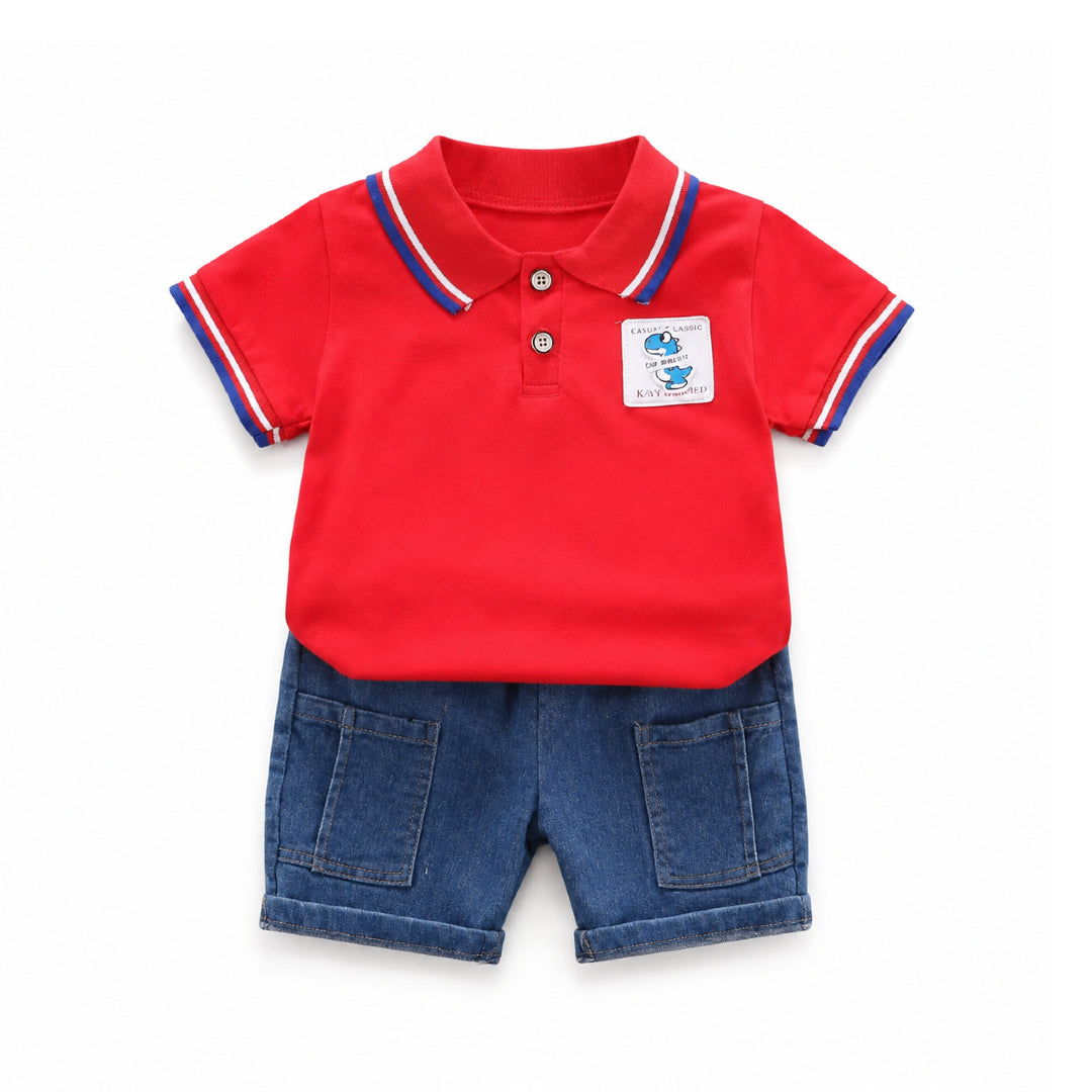 A baby boy's two-piece outfit consisting of a bright red short-sleeve polo shirt with blue and white striped collar and sleeve cuffs, and dark blue denim shorts with front patch pockets.