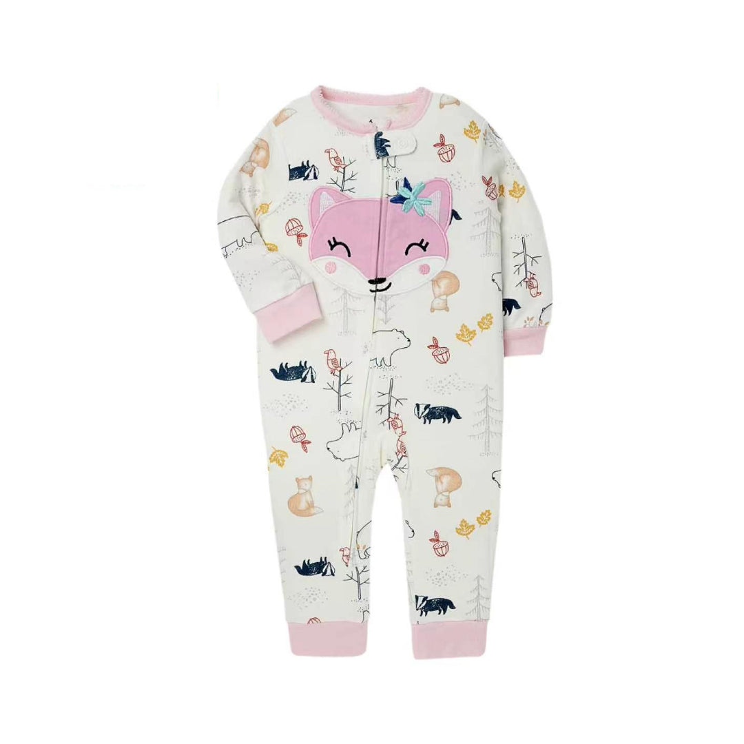A baby's long-sleeve zip-up footless pajama romper in an off-white color, decorated with a whimsical forest print featuring a large pink fox face on the chest, trees, squirrels, birds, and mushrooms. The cuffs and collar are solid pink.