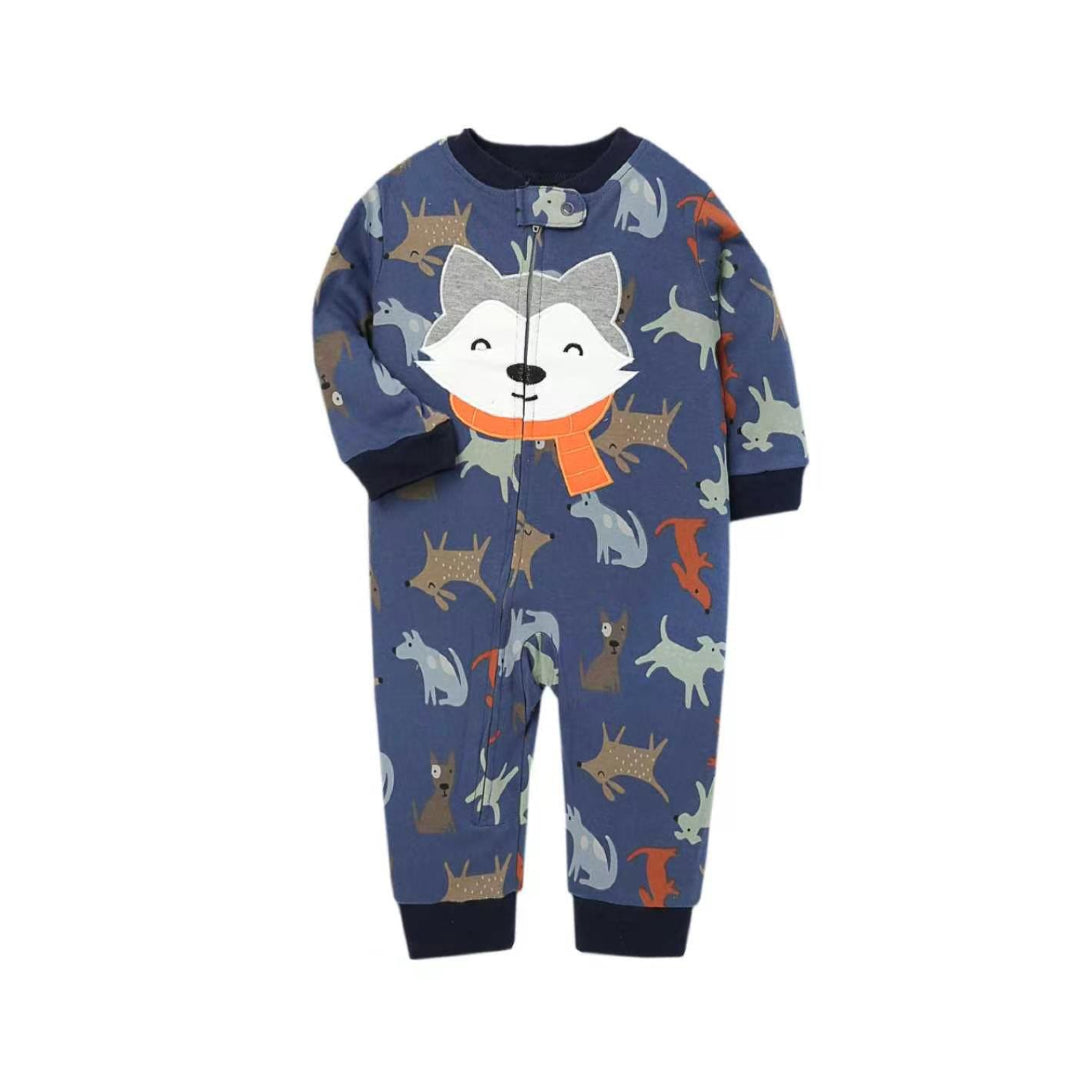 A baby's long-sleeve footless one-piece pajama or jumpsuit in navy blue, featuring an all-over print of cartoon foxes in various colors and a large fox face wearing an orange scarf on the chest. The garment has dark navy ribbed cuffs and hem, and a front zipper.